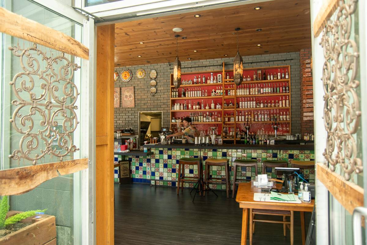 Diagram showing layered lighting in a home bar: ceiling pendants, under-cabinet LEDs, and accent shelf lighting