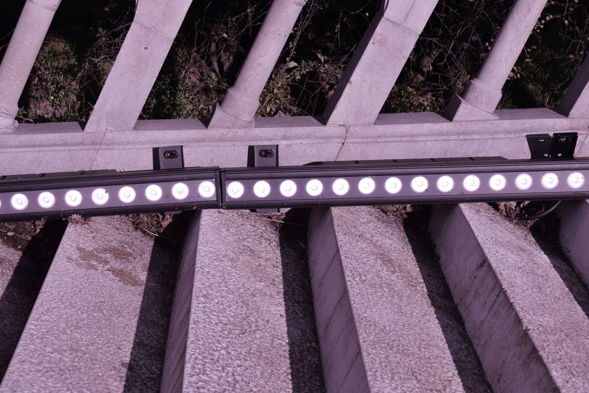 Side-by-side comparison: left shows uneven, shadowy bar lighting; right shows smooth, warm LED light bar fixture illuminating bottles evenly