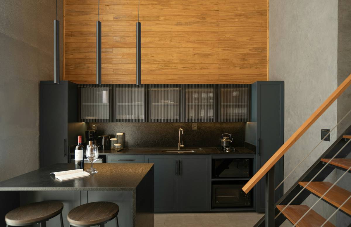 Modern kitchen with wooden accents and stainless steel appliances.