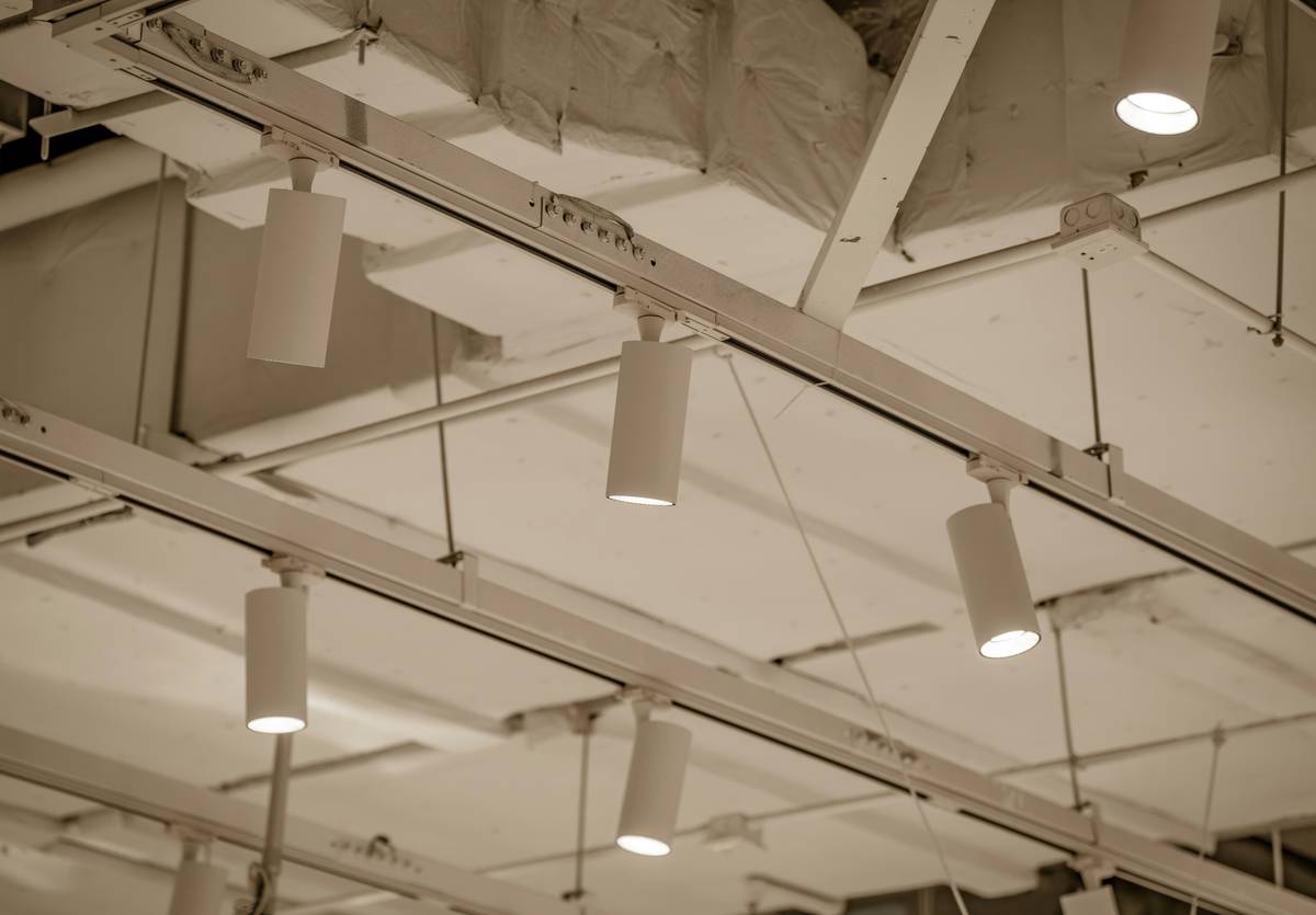 Side-by-side comparison of fluorescent vs LED t bar fixtures showing wattage, lumens, and color rendering index (CRI) differences