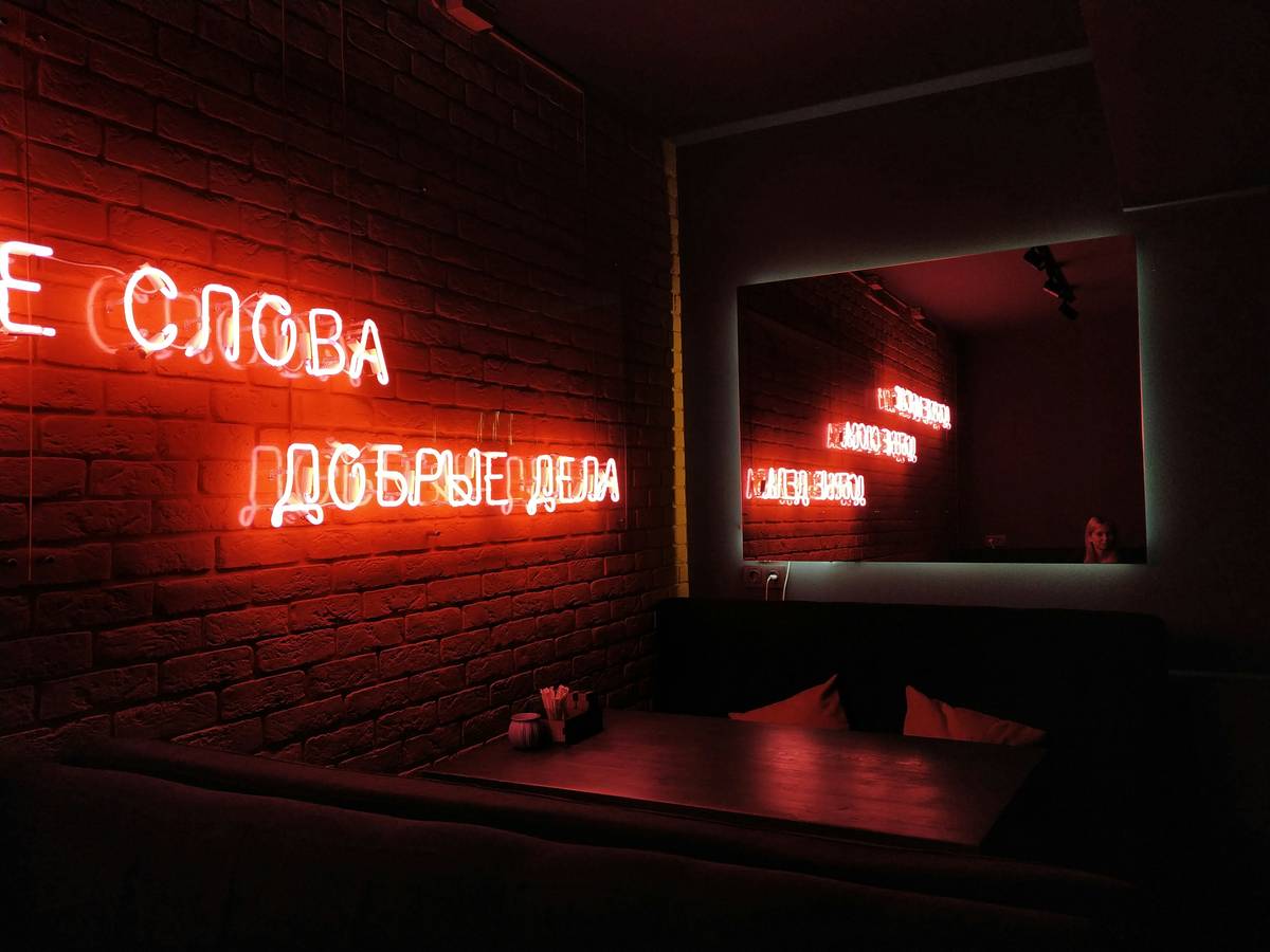 Modern bar wall lighting ideas with under-shelf LEDs and wall sconces creating ambient glow