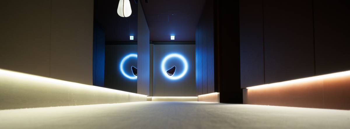 Smart minimal bar light installed under wooden shelving casting warm ambient glow